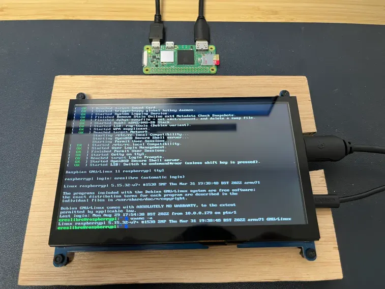 A Raspberry Pi Zero 2 connected to a 7-inch screen. The console output shows the ARM 32-bit operating system after loading it